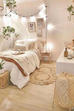 a bedroom decorated in white and pink with lights on the ceiling, bedding and rugs