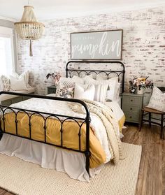 a bed room with a neatly made bed next to a window and a rug on the floor