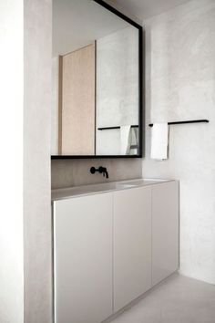 a bathroom with a large mirror above the sink