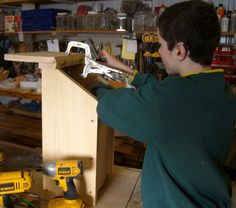 a young man working with tools in a workshop