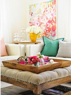 a living room filled with lots of furniture and colorful pillows on top of each other