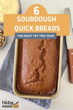 a loaf of bread sitting on top of a table next to other foods and utensils