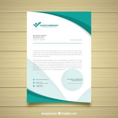 a green and white letterhead on a wooden background