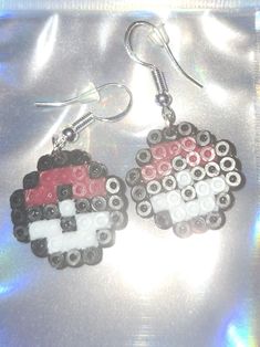 the earrings are made out of legos and have black, white, and red beads