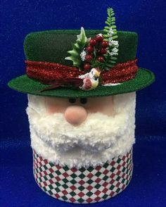 a close up of a santa claus wearing a green hat