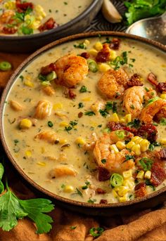 two bowls filled with shrimp and corn chowee