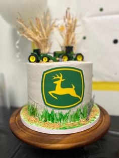 there is a cake decorated with an image of a deer and tractor on the side