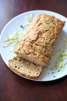 a loaf of zucchini bread sitting on top of a white plate