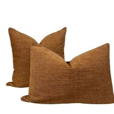 two brown pillows sitting on top of each other