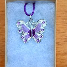 Handmade Purple Crystal Butterfly Necklace Made With Enamel Butterfly On Purple Cord Chain. Pendant Butterfly Measures 28mm In Shining Plated Silver. Pendant Features Enamel Purple Shades With Purple Crystal Stones. The Butterfly Is A Symbol Of Endurance And Hope. Chain Is Adjustable With Claw Clasp Closure. Box Display Only. Pouch Included Free. New And Unused Item. Contact Me With Any Offers. Silver Butterfly Pendant Necklace For Her, Silver Butterfly Pendant Necklace As Gift For Her, Purple Charms Necklaces As A Gift, Adjustable Nickel Free Silver Butterfly Necklace, Adjustable Silver Butterfly Pendant Necklace, Silver Adjustable Butterfly Pendant Necklace, Adjustable Metal Butterfly Necklace Gift, Silver Adjustable Butterfly Necklace For Gift, Adjustable Metal Butterfly Necklace For Gifts