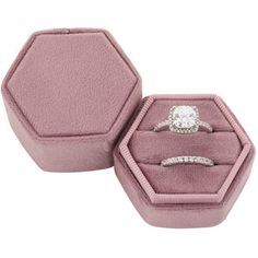 an open pink velvet ring box with two engagement rings in it and one diamond set on top