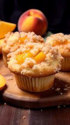 two peaches and some muffins on a cutting board