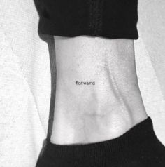 a woman's wrist with the word forward tattooed on her left side ribcage