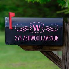 a black mailbox with the letter w on it's front and pink lettering