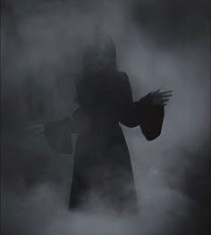 a person with their hands out in the fog