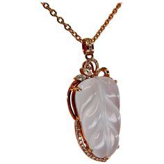 Please check out the HD video! This pendant is certified by two labs to be natural jadeite jade. The pendant is set in 18k rose gold and white diamonds. The well carved colorless icy jade leaf motif has an estimated 0.15 cts of diamonds in the setting. Extremely clean and colorless jades are rare and highly sort after. The meaning behind the jade leaf carving is that the wearer will receive good fortune and richness. This is a nice Jade pendant necklace made with a very high translucent colorles Art Deco Pendant Necklace, Leaf Carving, Jade Pendant Necklace, Antique Necklaces, Chinese Jewelry, Art Deco Pendant, Leaf Motif, Rose Gold Chain, Antique Necklace