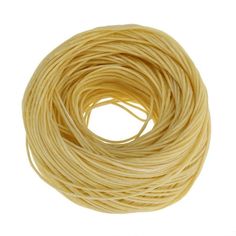 a spool of yellow string on a white background