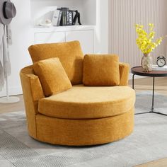 a living room with a round chair in the middle and yellow pillows on the back