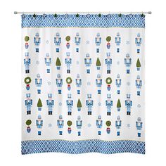 a blue and white shower curtain with robot design on the front, and trees in the back