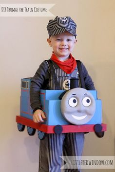 a boy in a train costume with a smile on his face and the words diy thomas the train costume