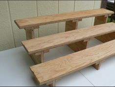 three wooden benches sitting next to each other