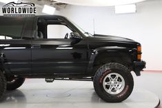 a black truck is parked in a garage