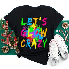 Buy Let’s Glow Crazy Colorful Party Shirt at Fantasywears. Hight quality products with perfect design is available in a spectrum of colors and sizes, and many different types of shirts! Unisex T-Shirt – 100% Cotton (fiber content may vary for different colors) – Medium fabric (5.3 oz/yd² (180 g/m²)) – Classic fit – Tear away the label – Runs true to size Women T-Shirt – 100% combed ringspun cotton (fiber content may vary for different colors) – Light fabric (4.3 oz/yd² (146 g/m²)) – Slim fit with a longer body length – Tear away the label – Runs smaller than [...] Trendy Funny Print T-shirt For Parties, Colorful Trendy Party Tops, Trendy Colorful Party Tops, Multicolor Crew Neck Top For Rave, Trendy Multicolor Letter Print Shirt, Trendy Multicolor Shirt With Letter Print, Fun Multicolor Party Tops, Fun Multicolor Tops For Party, Multicolor Short Sleeve Party Shirt