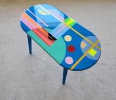 a colorful coffee table sitting on top of a carpeted floor