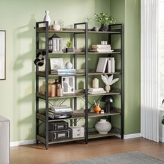 a living room with green walls and furniture in the corner, including a bookshelf