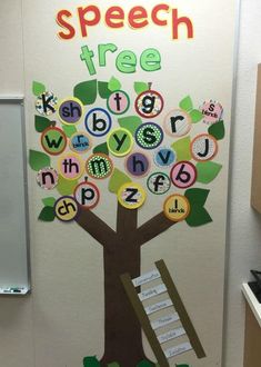 a classroom door decorated with an apple tree and alphabets on the front, which are cut out into letters