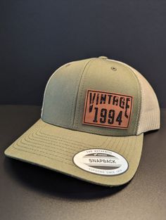 Custom Personalized Vintage "ANY YEAR" snap back cap.  Select your hat color and enter the Vintage Year required. The patch will be made with the year you enter so please be accurate. We make our patches in house and take a great deal of pride in every product we ship. You will love this hat! Hat Brand: YP Classic (Yupoong) Premium 6 Panel Trucker Snapback Hat Hat Color: Various Colors to Choose from Fabric: Cotton-Poly/Nylon Mesh Size: Adjustable Snapback One Size Fits Most Crown Height: 3 1/2 Cheap Snapback Baseball Cap For Birthday, Cheap Casual Snapback Hat With Letter Patch, Affordable Snapback Hat With Letter Patch, Custom Birthday Gifts, Crown Heights, Vintage Patches, Vintage Cap, Birthday Hat, Vintage Birthday