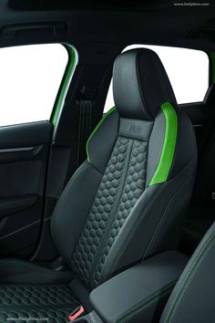 the interior of a car with green stitching and black leather trims, including two seats