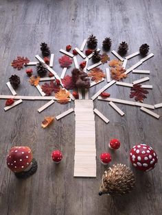 a wooden table topped with lots of different types of mushrooms and leaves on top of it