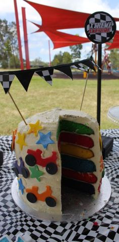 there is a cake that has been decorated with different colors and shapes on the table