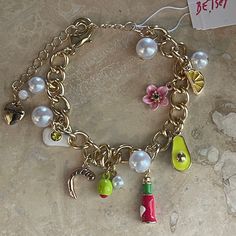 Betsey Johnson Designer Jewelry. Martini charm bracelet. Pearls and  charms. Gold chain with extender. One size will adjust to fit all. Original retail price $68 Themed Gold Charm Bracelet, Whimsical Gold Charm Bracelet, Adjustable Whimsical Charm Bracelet, Vintage Betsey Johnson Jewelry, Bracelet Pearls, Betsey Johnson Bracelet, Purse Essentials, Betsey Johnson Jewelry