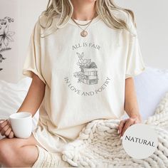 a woman sitting on a bed holding a cup