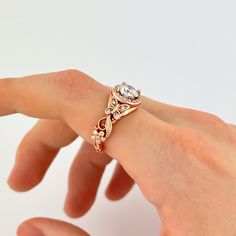 a woman's hand holding an engagement ring