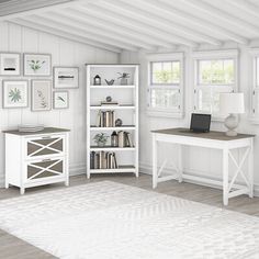 a computer desk sitting in the middle of a room