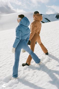 two people are walking in the snow together