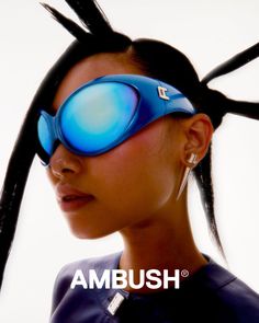 a woman with long black hair and blue goggles on her face is looking to the side