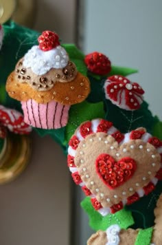 some cupcakes are hanging on a doorknob with red and white sequins