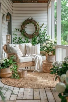 the porch is decorated with wicker furniture and flowers