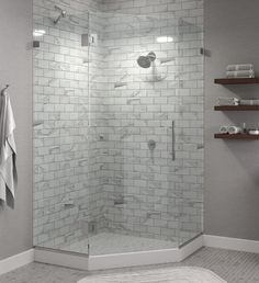 a bathroom with a walk in shower next to a white towel rack and shelves on the wall