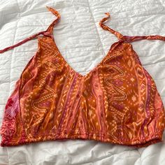 Never Worn Orange V-neck Top For Festivals, Summer Orange Tank Top, Orange Cropped Top For Beach, Orange Printed Sleeveless Top, Casual Triangle Top For Festivals, Printed Tank Top For Beach, Orange Cropped Tops For Vacation, Orange Crop Top For Day Out, Casual Multicolor Triangle Top