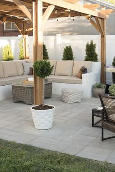 an outdoor living area with couches, tables and chairs