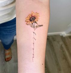 a sunflower with the word love written in cursive writing on its arm