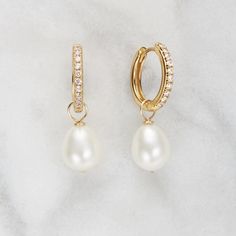 These stunning gold diamond-style large pearl drop earrings feature removable pearls to dress your look up or down depending on the occasion. These versatile hoops will complement a wedding dress on a bride's big day or can be worn by the bridesmaids and flower-girls too. These hoops are hinged to be put on with incredible ease.   Available in solid sterling silver or 18ct gold plated sterling silver. To keep your jewellery shining bright, we recommend giving it a little care over time. By using a soft, lint-free jewellery cloth, you can remove blemishes that result from body oils, perfumes and lotions, whilst protecting the finish on your beautiful Lily & Roo jewellery from future damage.  TOP TIPS Avoid the five S's - Sleep, Shower, Swim, Sprays (perfumes) & Sweat (exercise).  Always ens Gold Pearl Wedding Earrings, Classic Wedding Earrings, Wedding Jewelry Ideas For Bride Gold, Rakhadi Designs, Gold Wedding Jewellery, Gold Bridal Jewellery, Bride Earrings Pearl, Pearl Gold Earrings, خواتم خطوبة