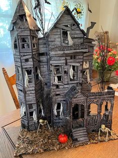 a wooden table topped with a halloween house