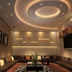 a living room with couches and a flat screen tv mounted on the wall above it