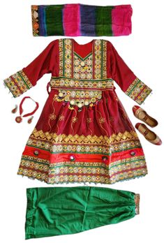 a red dress with green pants and shoes on top of the clothes is next to a headband